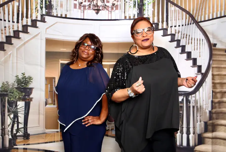 Felicia and Carmen of Southern Gals dressed up in front of a spiral staircase